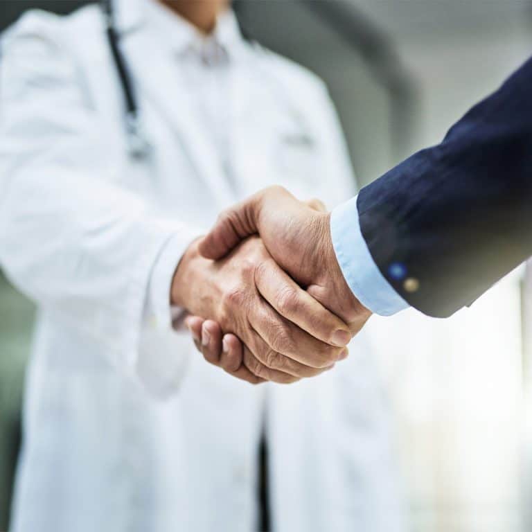 businessman and doctor shaking hands