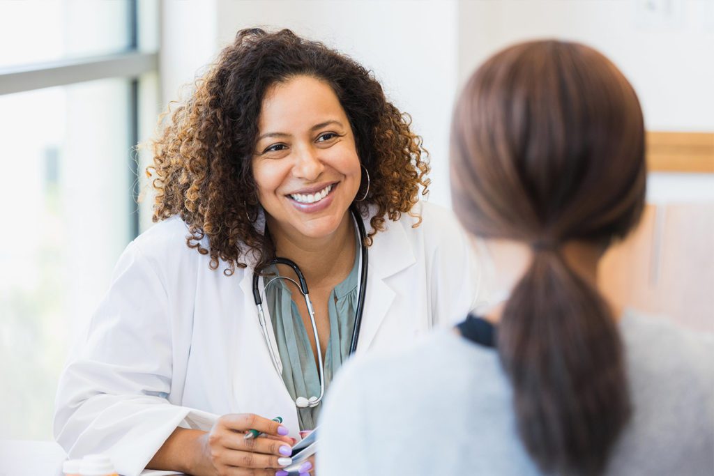 Smiling female doctor talking to a patient